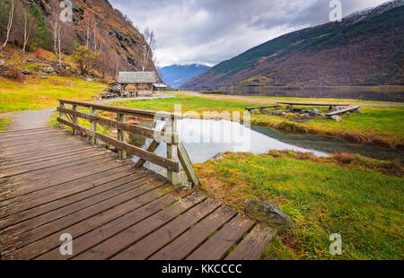 Small wooden bridge on a path leading to the fjord shore in small village Flam, Norway Stock Photo