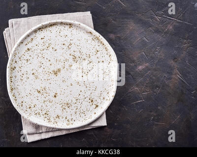 White craft plate on black slate table Stock Photo