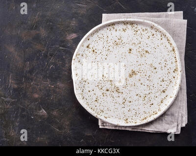 White craft plate on black slate table Stock Photo
