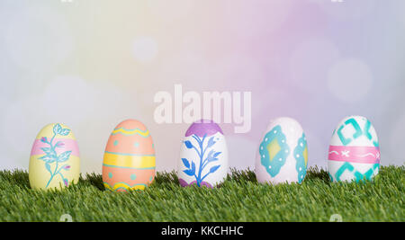 Easter eggs on grass with a colorful background Stock Photo