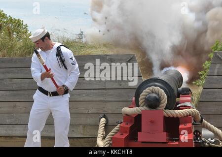 Gunner's Mate 2nd Class Jason Streets, from Elk Garden, WVa, assigned to Navy Munitions Command, fires a 18-pounder garrison cannon during the parade of ships passing at Baltimore Navy Week 2012, Baltimore, Maryland, 2012. Image courtesy Mass Communication Specialist 1st Class Kenneth Robinson/US Navy. Stock Photo