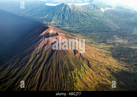 Mount Agung and its shadow from sunrise with mount Abang and mount Batur in the background. Stock Photo