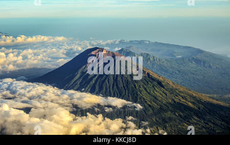 Mount Agung and the blanket of cloud with mount Abang and mount Batur in the Background. Stock Photo