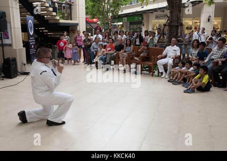 Musician 2nd Class Charlie Perkes, a member of the US 7th Fleet Far East Edition Band, sings in front of an audience of Thai nationals during a show at the Chrystal Community Mall in Bangkok, Thailand. Image courtesy Mass Communication Specialist 3rd Class Colin M. Sheridan/US Navy, 2012. Stock Photo