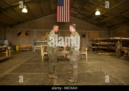 U.S. Army Gen. Robert Abrams, commanding general of U.S. Army Forces Command, promotes a young Soldier, deployed in support of Combined Joint Task Force – Operation Inherent Resolve and assigned to the 458th Engineer Battalion, to the rank of specialist at Camp Taji, Iraq, Nov. 16, 2017. Camp Taji is one of four CJTF-OIR building partner capacity locations dedicated to training partner forces and enhancing their effectiveness on the battlefield. CJTF-OIR is the global Coalition to defeat ISIS in Iraq and Syria. (U.S. Army photo by Cpl. Rachel Diehm) Stock Photo