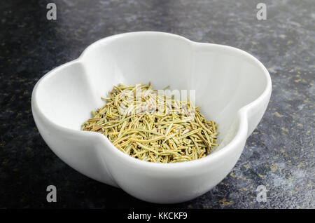 The Herb Rosemary (Rosmarinus officinalis) in a White Bowl Stock Photo