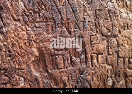 Carved graffiti, some dating to the 19th century, on the trunk of a giant sequoia redwood tree in Tuolumne Grove of Yosemite National Park, Yosemite Valley, California, 2016. Stock Photo