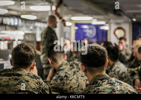 U.S. Marine Corps 1st Sgt. Christian Appleman, first sergeant of Fox Company, 2nd Battalion, 6th Marine Regiment, 26th Marine Expeditionary Unit (MEU), and senior enlisted advisor aboard the dock landing ship USS Oak Hill (LSD 51), leads a guided discussion as the culminating event of a Lance Corporal Seminar aboard the Oak Hill, during Combined Composite Training Unit Exercise (COMPTUEX) in the Atlantic Ocean Nov. 25, 2017. Combined COMPTUEX serves as the capstone event for the Amphibious Ready Group-MEU team prior to a deployment, fully integrating the ARG-MEU team as an amphibious force and Stock Photo