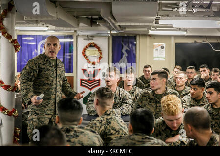 U.S. Marine Corps 1st Sgt. Christian Appleman, first sergeant of Fox Company, 2nd Battalion, 6th Marine Regiment, 26th Marine Expeditionary Unit (MEU), and senior enlisted advisor aboard the dock landing ship USS Oak Hill (LSD 51), leads a guided discussion as the culminating event of a Lance Corporal Seminar aboard the Oak Hill, during Combined Composite Training Unit Exercise (COMPTUEX) in the Atlantic Ocean Nov. 25, 2017. Combined COMPTUEX serves as the capstone event for the Amphibious Ready Group-MEU team prior to a deployment, fully integrating the ARG-MEU team as an amphibious force and Stock Photo