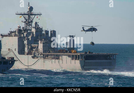 ATLANTIC OCEAN (Nov. 26, 2017) The amphibious dock landing ship USS Oak Hill (LSD 51) receives a vertical replenishment from the fleet replenishment oiler USNS Big Horn (T-AO 198). Iwo Jima, components of the Iwo Jima Amphibious Ready Group and the 26th Marine Expeditionary Unit are conducting a Combined Composite Training Unit Exercise that is the culmination of training for the Navy-Marine Corps team and will certify them for deployment. (U.S. Navy photo by Mass Communication Specialist Seaman Dary M. Patten/Released) Stock Photo