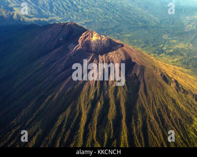 The crater of mount Agung as seen from airplane window with mount Abang and mount Batur in the background. Stock Photo