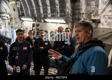 Matthew Smith, 60th Aerial Port Squadron load director, briefs members of Federal Emergency Management Agency on the procedures of loading cargo onto a C-17 Globemaster III aircraft at Travis Air Force Base, Calif., Nov. 27, 2017. Smith was FEMA's U.S. Air Force liaison during the agency's joint loading evaluation and helped its members through his extensive knowledge of the C-17. (U.S. Air Force photo by Airman 1st Class Christian Conrad/Released) Stock Photo