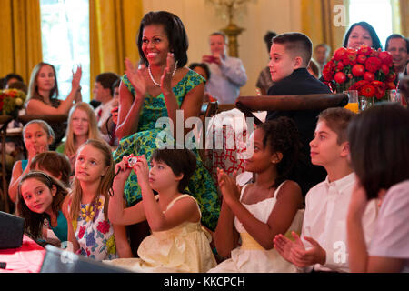 First Lady Michelle Obama and guests watch Big Time Rush perform during the Kids' State Dinner in the East Room of the White House, Aug. 20, 2012. (Official White House Photo by Sonya N. Hebert)  This official White House photograph is being made available only for publication by news organizations and/or for personal use printing by the subject(s) of the photograph. The photograph may not be manipulated in any way and may not be used in commercial or political materials, advertisements, emails, products, promotions that in any way suggests approval or endorsement of the President, the First F Stock Photo