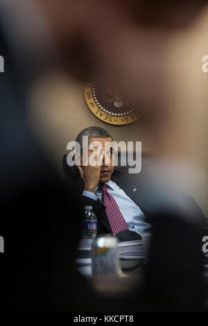 President Barack Obama is briefed in advance of his trip to the Republic of Korea during a meeting in the Situation Room of the White House, March 23, 2012. Stock Photo