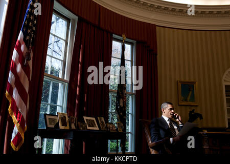 President Barack Obama talks on the phone with Palestinian Authority President Mahmoud Abbas in the Oval Office, March 19, 2012. Stock Photo