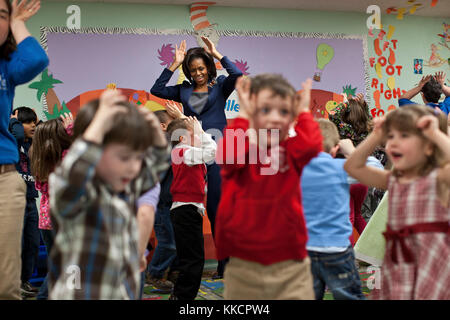 First Lady Michelle Obama participates in the 'Bunny Pokey' song and dance with kids in the Kinderbees Activty Room at Penacook Community Center in Penacook, N.H., March 9, 2012. Stock Photo