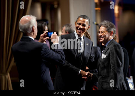 President Barack Obama stands with keynote speaker Eric Metaxas as Vice President Joe Biden takes their photo during the National Prayer Breakfast at the Washington Hilton Hotel in Washington, D.C., Feb. 2, 2012. Stock Photo