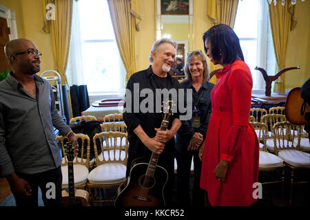 First Lady Michelle Obama talks with Darius Rucker, Kris Kristofferson and Lisa Meyers in the Old Family Dining Room of the White House before “The History of Country Music: From Barn Dances to Pop Charts” interactive workshop for local students, Nov. 21, 2011. Stock Photo
