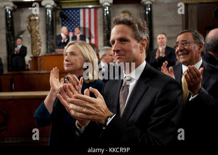 Secretary of State Hillary Rodham Clinton, Treasury Secretary Timothy Geithner and Defense Secretary Leon Panetta applaud as President Barack Obama enters the House Chamber of the U.S. Capitol in Washington, D.C., for his address to a Joint Session of Congress detailing the American Jobs Act, Sept. 8, 2011. Stock Photo