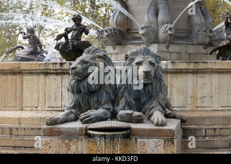 Close up of the sculpted lions of the Fountaine de la Rotonde in Aix en Provence, France. Fish and swan fountains are in the background. Stock Photo