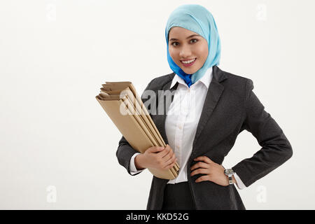 malay business woman happy holding small stack of files Stock Photo