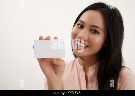 woman showing empty blank paper card sign with copy space for text. female model isolated on white background. Stock Photo