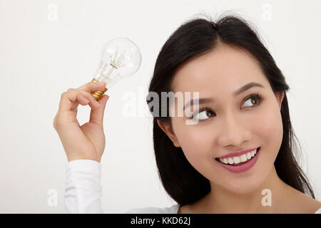 malay woman holding light bulb Stock Photo