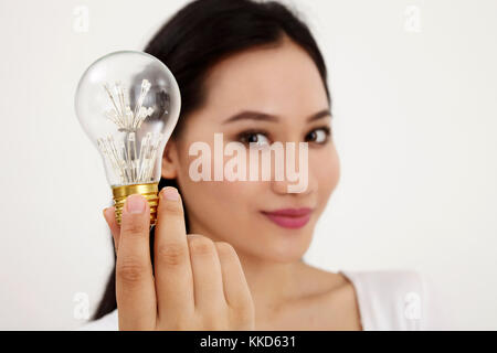 malay woman holding light bulb Stock Photo