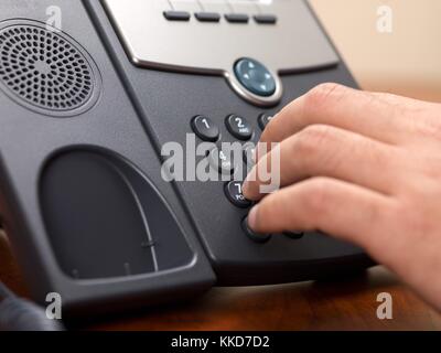 close up shot of a person dialing from a landline phone Stock Photo