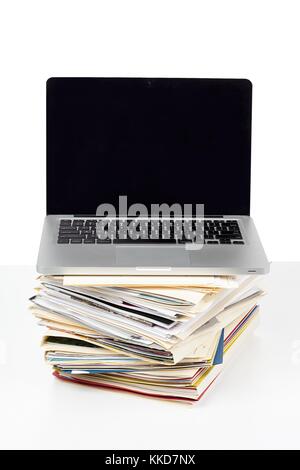 pile of folders with laptop on it Stock Photo