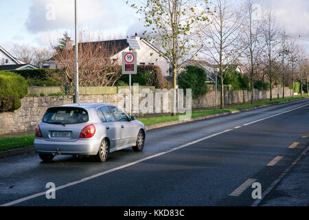 Speed control sign warning drivers to slow down if they are going too fast on the road with speed limit restriction. Stock Photo