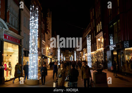 LONDON CITY - DECEMBER 24, 2016:  People walking between Christmas decorations in S Molton Street Stock Photo