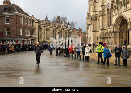 In the cold, crowd of people line the route on both sides of the road, before military parade outside York Minster  - North Yorkshire, England, UK. Stock Photo