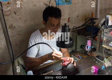 A jeweller at work in  Phsar Nath Market, Battambang, Cambodia Stock Photo