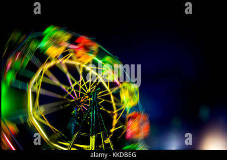 ferris wheel with neon light moving spin at night carnival park Stock Photo