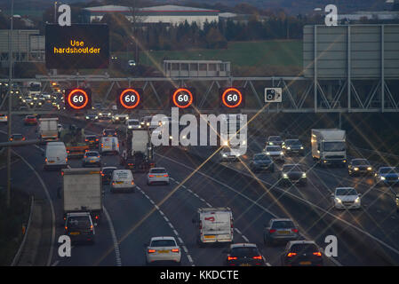 reduced speed limit and speed camera warning signs and speed on the m62 motorway leeds at dusk yorkshire united kingdom Stock Photo
