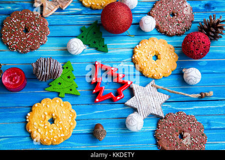 Christmas decorations and balls with cookies top view on painted wooden background Stock Photo