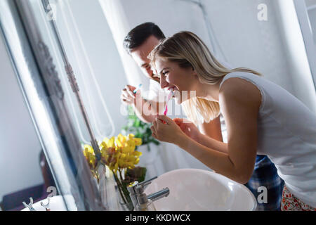 Attractive couple brushing teeth in morning together Stock Photo