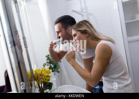 Attractive couple brushing teeth in morning together Stock Photo
