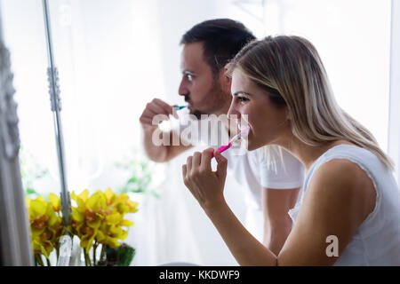Attractive couple brushing teeth in morning together Stock Photo