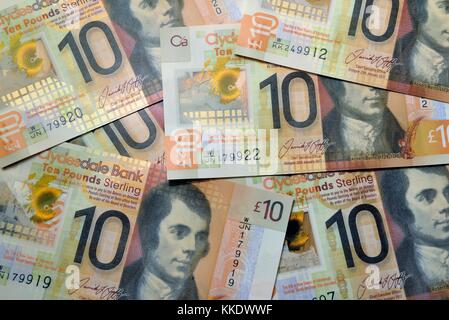 A pile of Clydesdale Bank, Scottish, plastic, ten pound notes with the face of poet Stock Photo