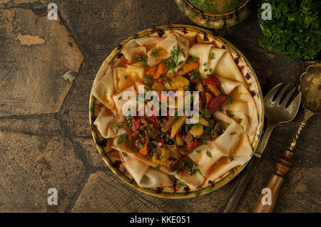 oriental dishes on decorative old tiles. dish dough Stock Photo