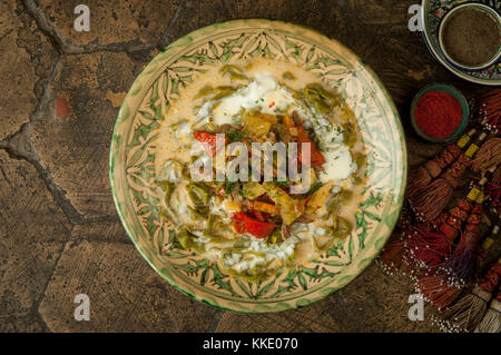 oriental dishes on decorative old tiles. Stock Photo