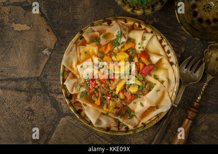 oriental dishes on decorative old tiles. dish dough Stock Photo