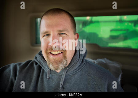 FARMER PORTRAIT SITTING IN COMBINE HARVESTER IN UTICA, MINNESOTA. Stock Photo