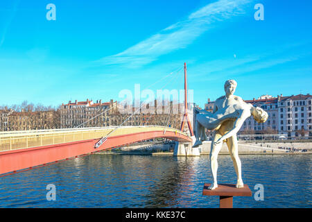 Lyon,  France - December 8, 2016: The Weight of Oneself sculpture with the Palais de Justice footbridge in the background Stock Photo