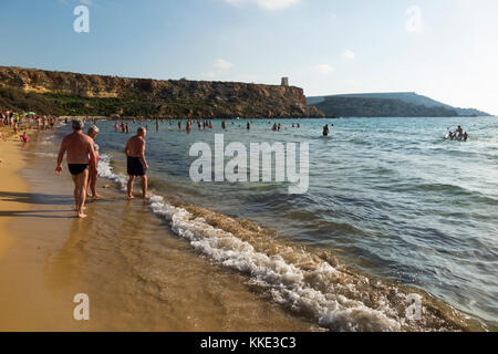 Sea and sandy beach with tourists / sunbathers people enjoying themselves swimming and sun bathing, at Golden Bay Beach, near Mellieha. Malta. (91) Stock Photo