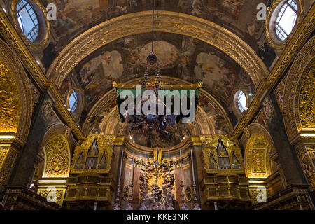 Baroque & highly decorated ceiling  (& suspended green altar canopy) above the nave / interior inside of St John's Co-Cathedral. Valletta, Malta Stock Photo