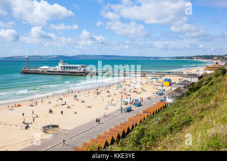 bournemouth dorset bournemouth beach west undercliff Bournemouth pier with tourists and holidaymakers on the beach Bournemouth dorset england uk gb Stock Photo