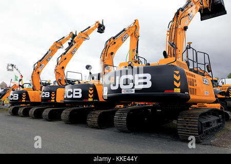 HYVINKAA, FINLAND - SEPTEMBER 8, 2017: Four JCB tracked excavators on display, from right JCB JS330, on Maxpo 2017. Stock Photo